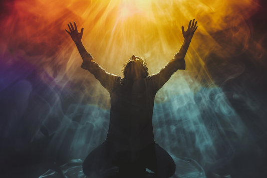 Person kneeling with raised arms in colorful light.