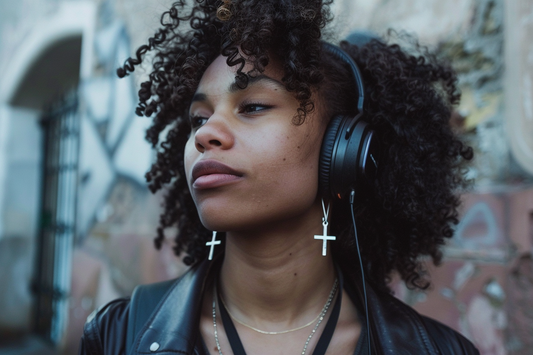 Person with headphones and cross earrings.